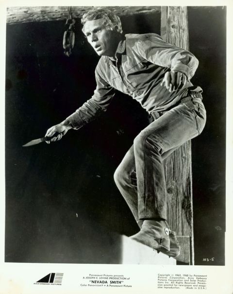 Max (McQueen), poised to attack, with knife in hand.